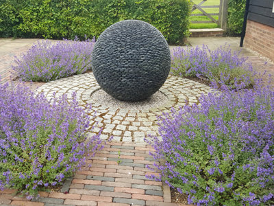 david harber dark planet garden sculpture using black polished pebbles