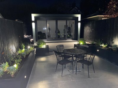 lighting set into a garden's black timber raised beds